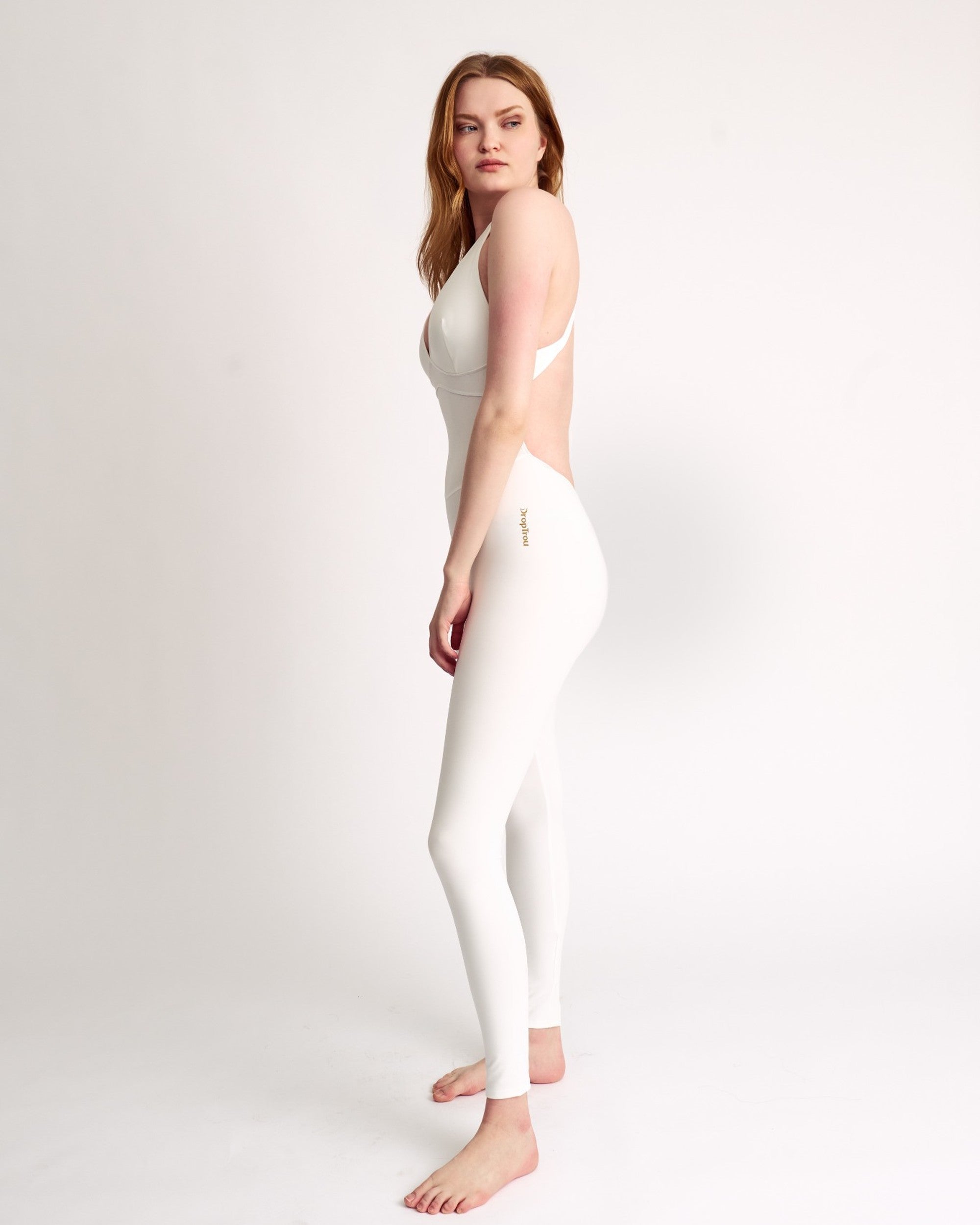 Woman wearing white DropTrou women's jumpsuit - small side studio view #Size_S