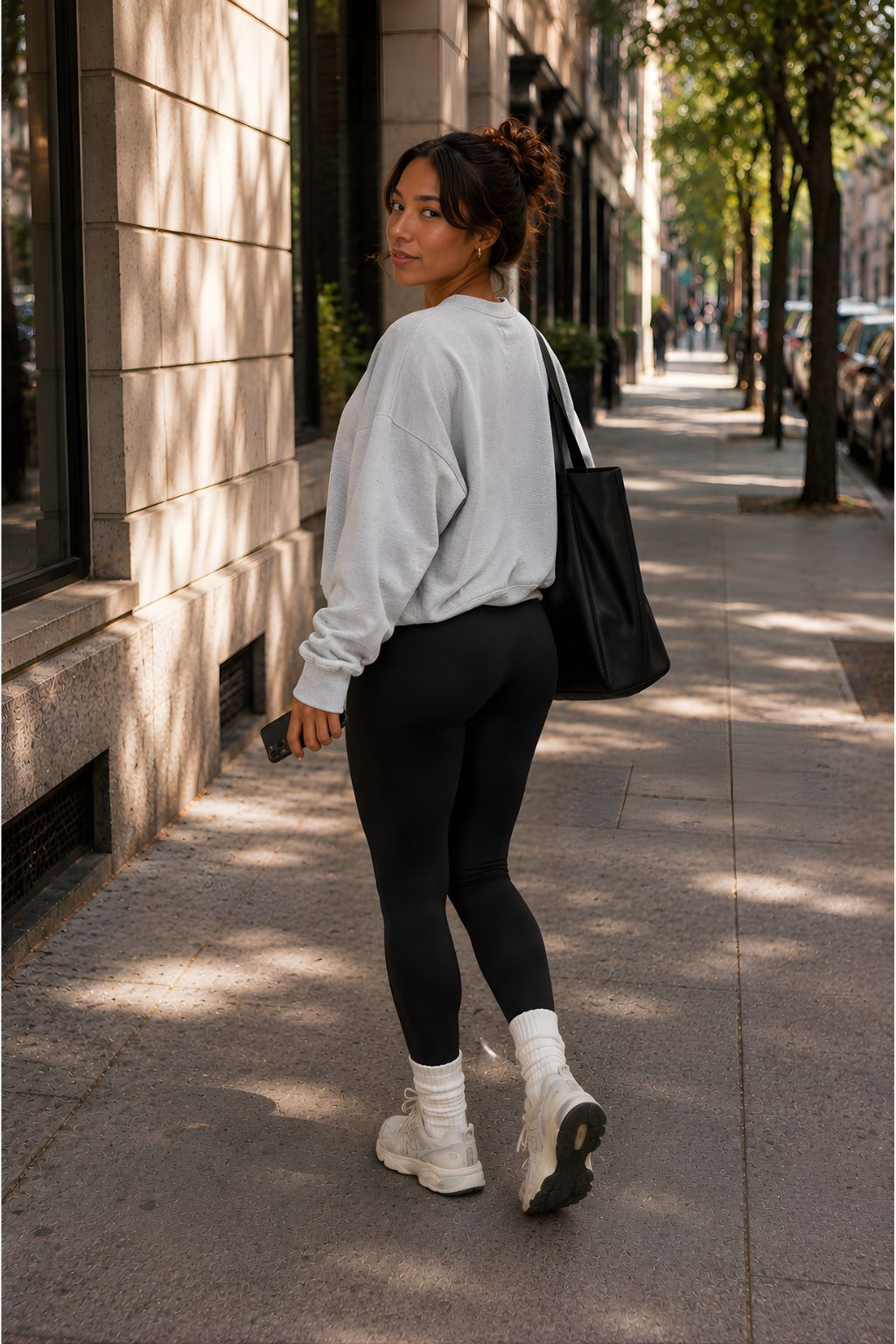 Woman wearing black DropTrou women's jumpsuit - extra small walking lifestyle view #Size_XS