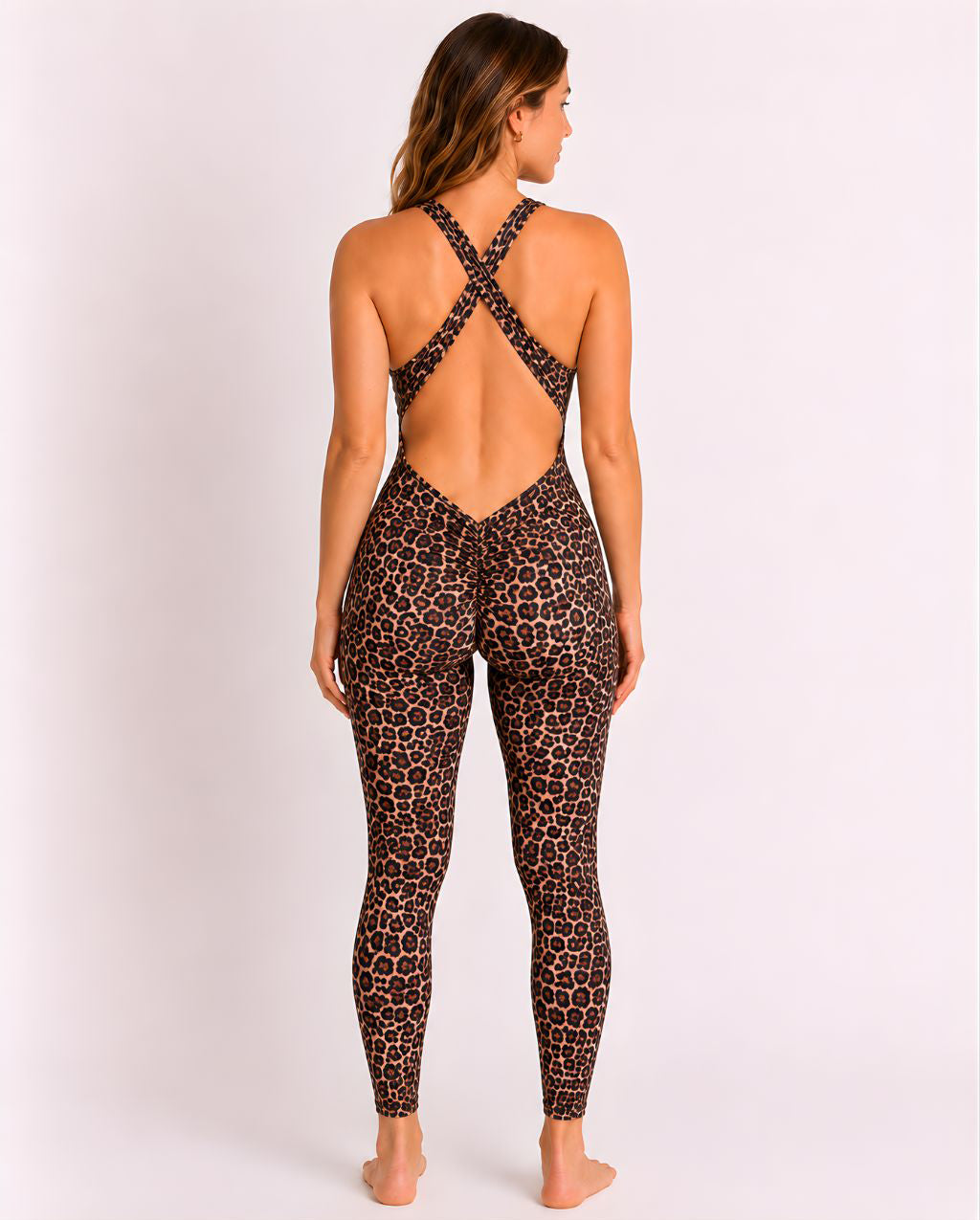 Woman wearing leopard DropTrou women's jumpsuit - medium back studio view #Size_M