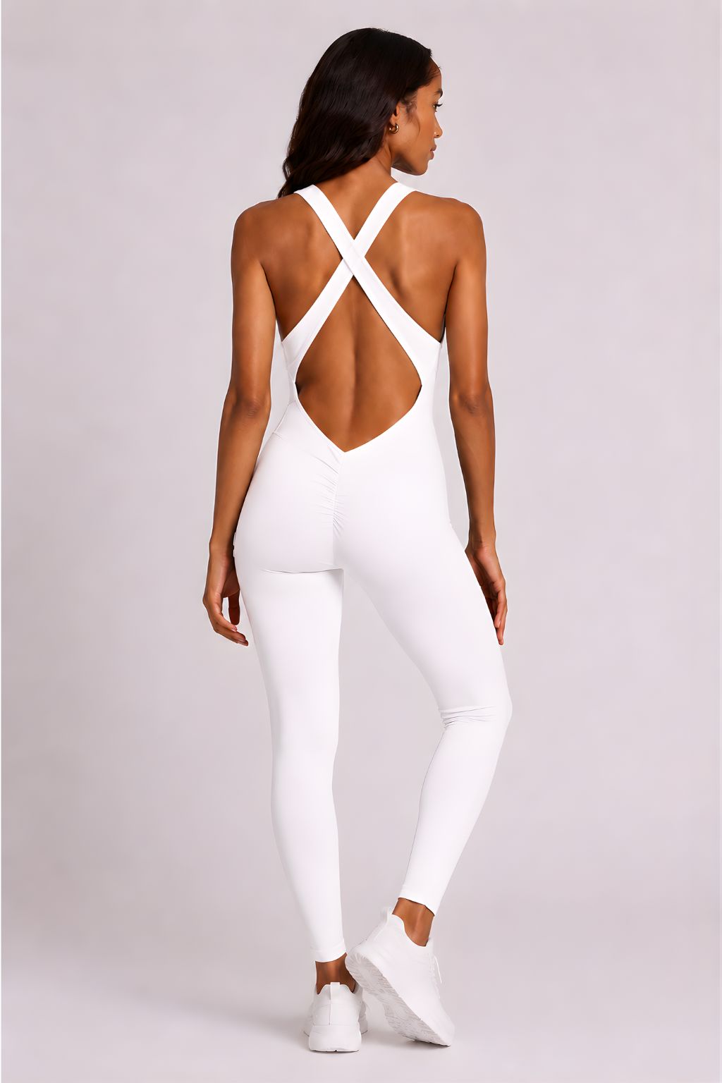 Woman wearing white DropTrou women's jumpsuit - extra small back studio view #Size_XS